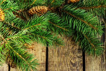 Fototapeta na wymiar Christmas decoration of fir tree on texture wood background