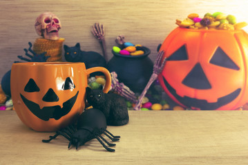halloween coffee cup with spider and cat and decor candy colorful background
