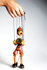 Pinocchio liar doll with big nose isolated on background