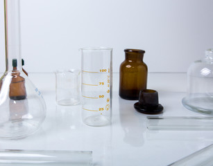 a table with glass material scientist in chemical lab