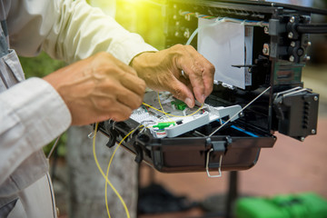 Technicians are install cabinet on fiber optic cable.