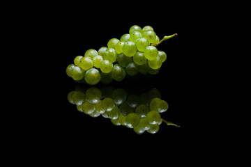 Bunch of green grapes on black