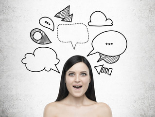Amazed woman and dialogue boxes on concrete wall