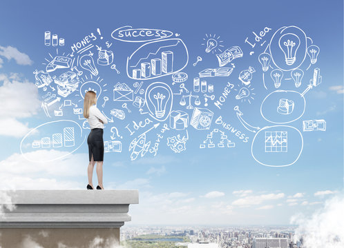 Blond girl standing on rooftop