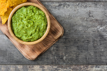 Nachos and  guacamole on wooden background

