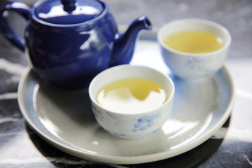 pouring tea into cup of tea in close up Chinese and Japan drink