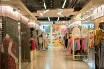 Blurred image of clothing boutique store interior. Defocused bac