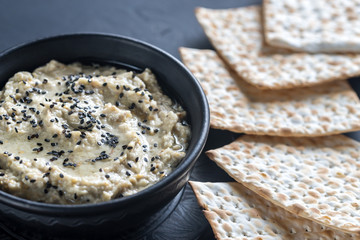 Bowl of baba ghanoush with matzo