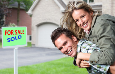 Happy couple near new house.