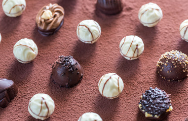 Chocolate candies on cocoa background