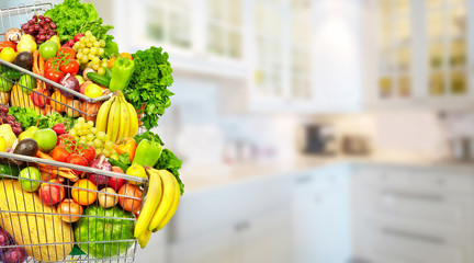 Vegetables and fruits over kitchen background.