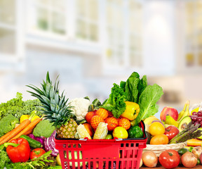 Vegetables and fruits over kitchen background.