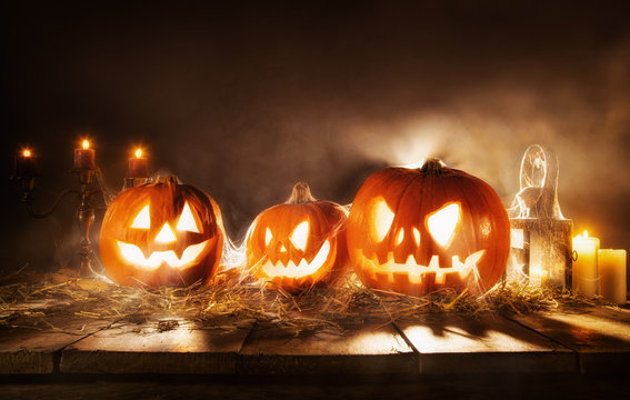 Scary halloween pumpkins on wooden planks
