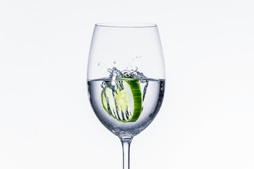 Cucumber drops into wine glass