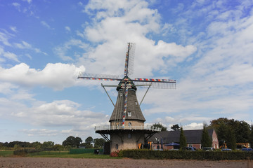 Naklejka premium Typical Dutch flour windmill near Veldhoven, North Brabant