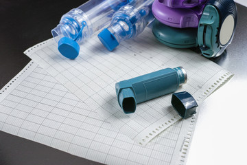 Asthma relief concept, salbutamol inhalers, medication and paper