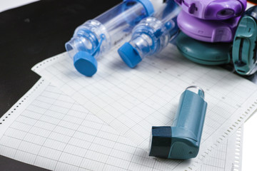Asthma relief concept, salbutamol inhalers, medication and paper