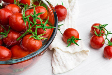 Tomatoes in water, cherry tomatoes on a light background, soft focus, horizontal