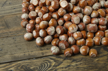 Whole hazelnuts arranged on a rustic wooden background to form a page header