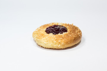 A piece of pie with strawberry jam on top on a white background.