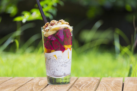 Glass of chia pudding with different fruits and cereals