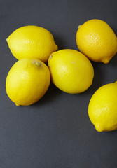 Lemons arranged on a rustic slate background