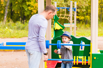 Obraz premium playful child with father at the playground outdoor.