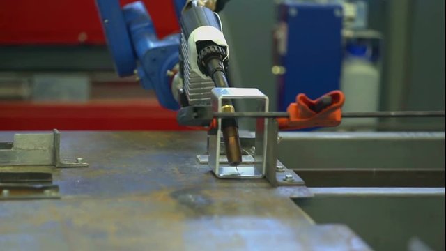 A drilling machine is designing something in a factory. Then they will make sun shading system. Close-up shot.
