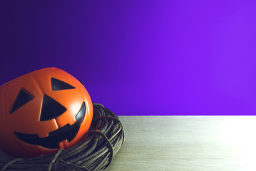 pumpkin ghost bucket in wood vine on purple background