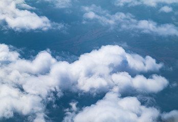 Naklejka na ściany i meble Aerial view of cloud and sky from airplane window looking down t