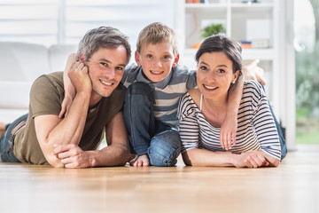 At home, a cheerful are lying on the wooden floor