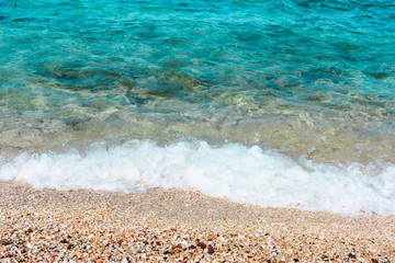 Sea beach as background. Shells and clear blue water in tropical sunny day