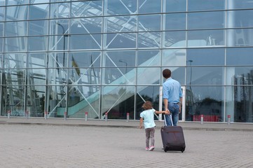 Man and little girl a going to the airplane.