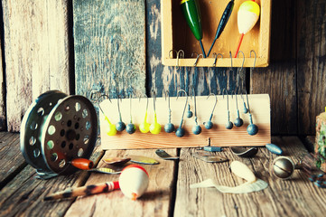 Fishing equipment on vintage wooden background