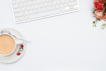 Coffee with computer keyboard and flower on white background