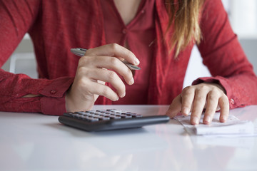 Woman hands with bills on table