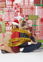Wall of gifts and couple wrapped with golden chain