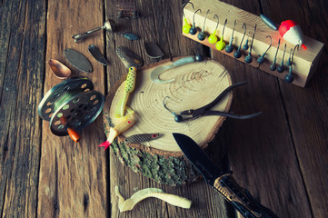 Fishing equipment on vintage wooden background. Top view