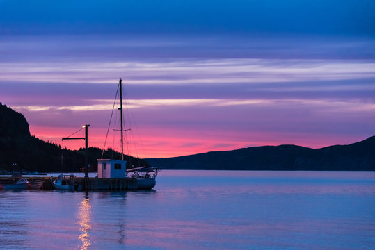 fishing boat docked at sunset