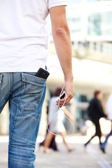 Holding cellphone with battery charger in pocket