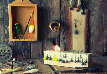 Fishing equipment on vintage wooden background