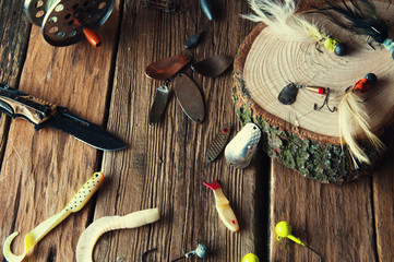Fishing equipment on vintage wooden background. Top view