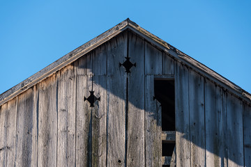 Peak of old barn in strong sunlight
