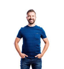 Fototapeta premium Hipster man in blue t-shirt, studio shot, isolated