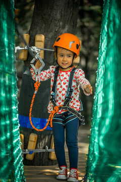 sports happy kid climbs through the ropes