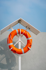 Orange life buoy on the pier