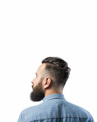 Fototapeta premium Portrait of a bearded man in a denim shirt, isolated on a white background. There is a spase for your text.