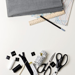 Everything for sewing in black and white. Fabric and thread, zip