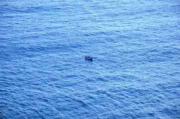 Fototapeta premium Little boat on the middle of the sea