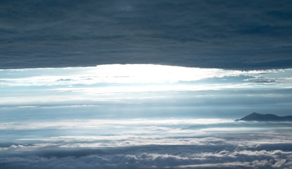 Mountain layer in morning sun ray and winter fog.